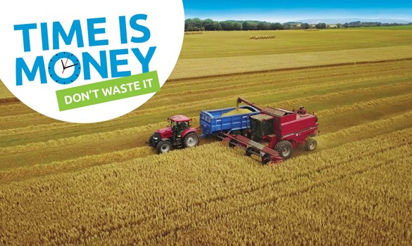 A combine harvester in a field of crops